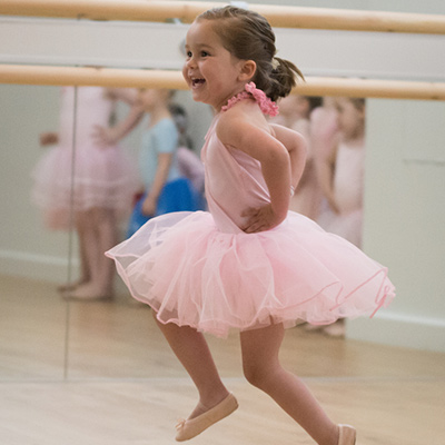 Ballet student smiling and dancing